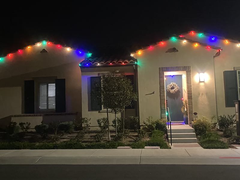 Single-story Camarillo home with multicolor roofline lights and a wreath on the door