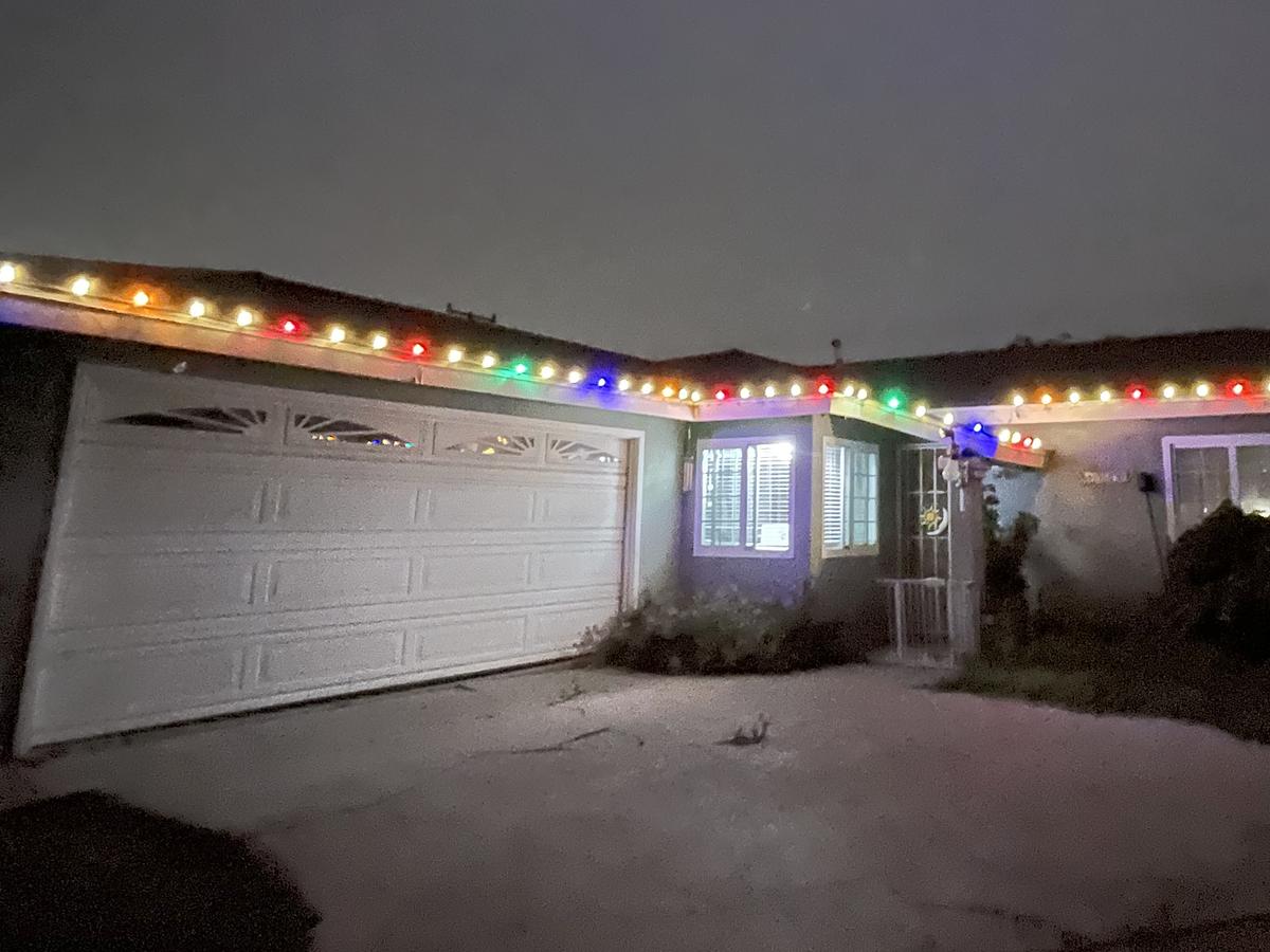 Single-story home with multicolor lights along the roofline