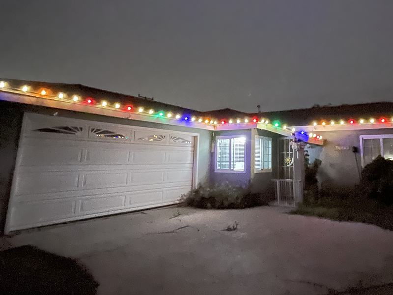 Single-story home with multicolor lights along the roofline