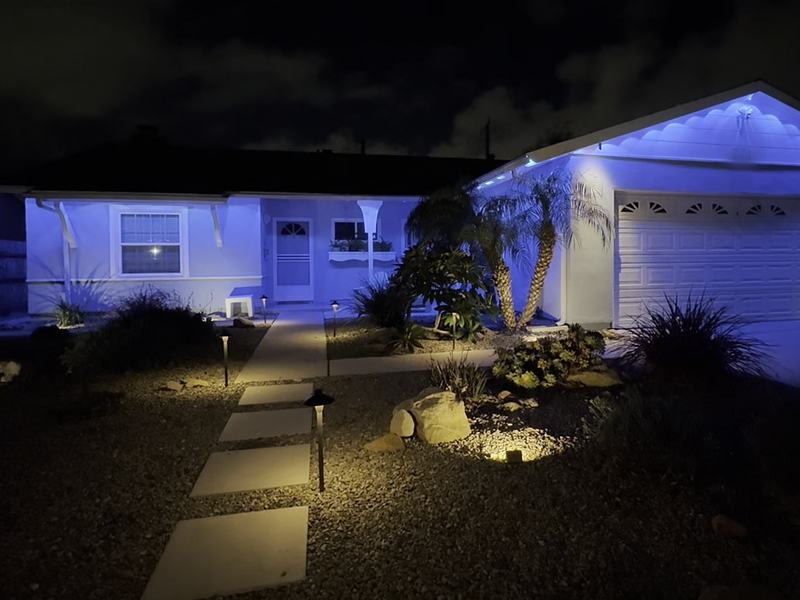 Single-story Ventura home with permanent lights set to blue and warm path lights