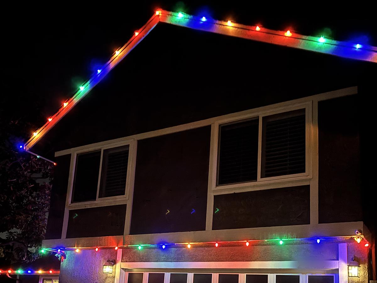 Ventura home with multicolor lights along the roof peak and above the garage