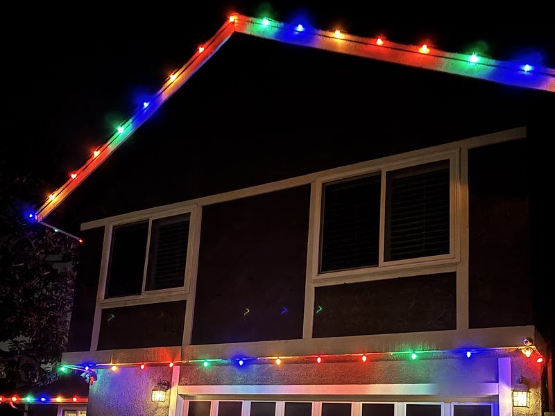 Ventura home with multicolor lights along the roof peak and above the garage